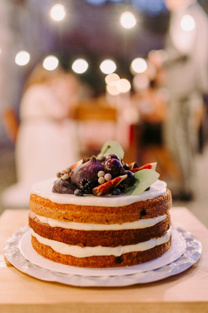 pexels-photo-1721934-1721934 Shallow Focus of White Icing-covered Cake on White Ceramic Plate